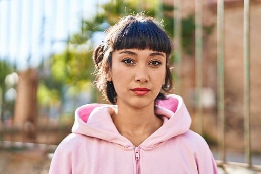 hip woman in pink hoodie upset