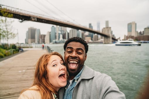 happy couple posing for NYC selfie