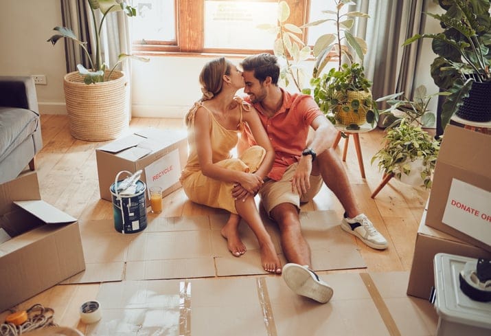 Couple sharing embrace on floor.
