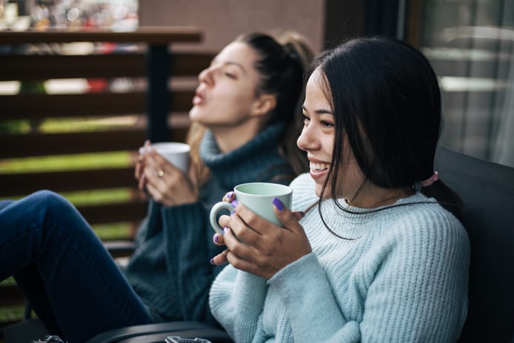 female friends having tea outside