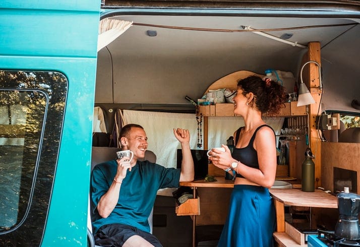 couple on road trip having coffee