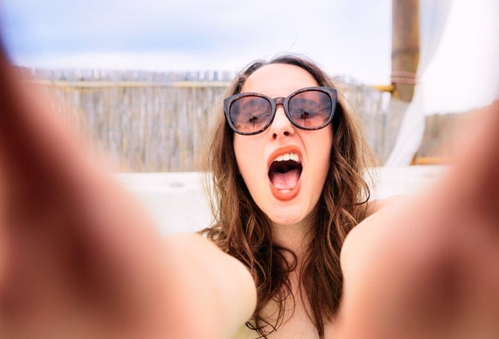 Woman making funny face in selfie.
