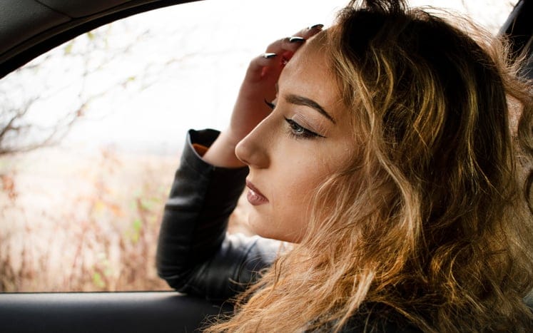 woman with long blonde hair in a car