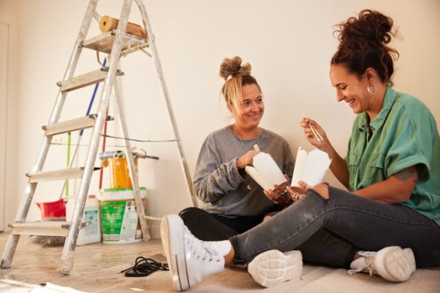 couple eating chinese between painting