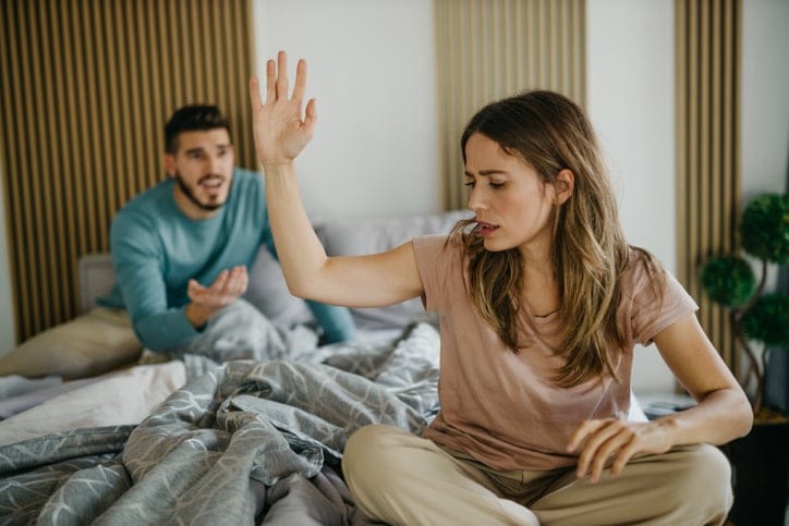 couple fighting in bed