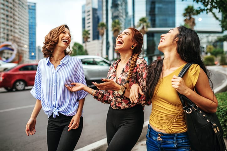 Group of friends laughing and walking together.