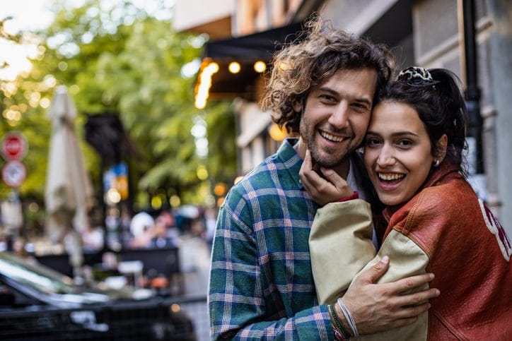 couple embracing outside on city street