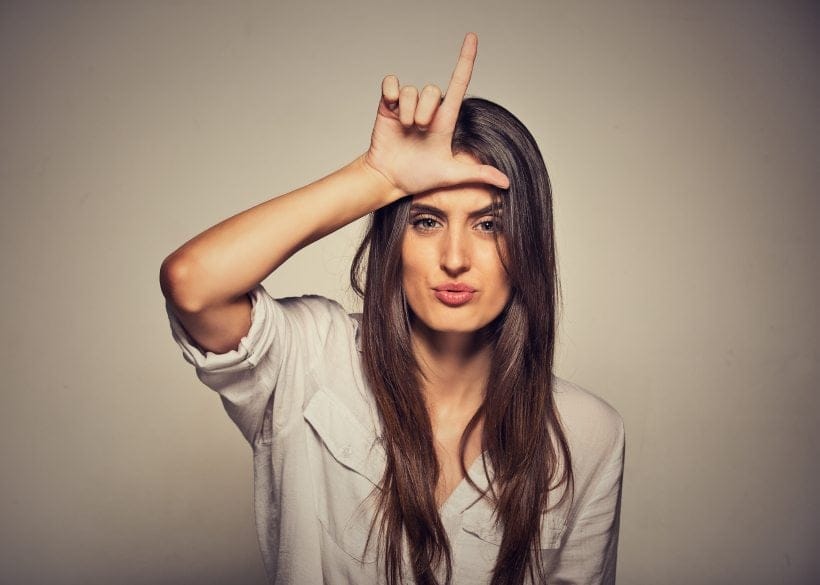 woman doing L sign on forehead
