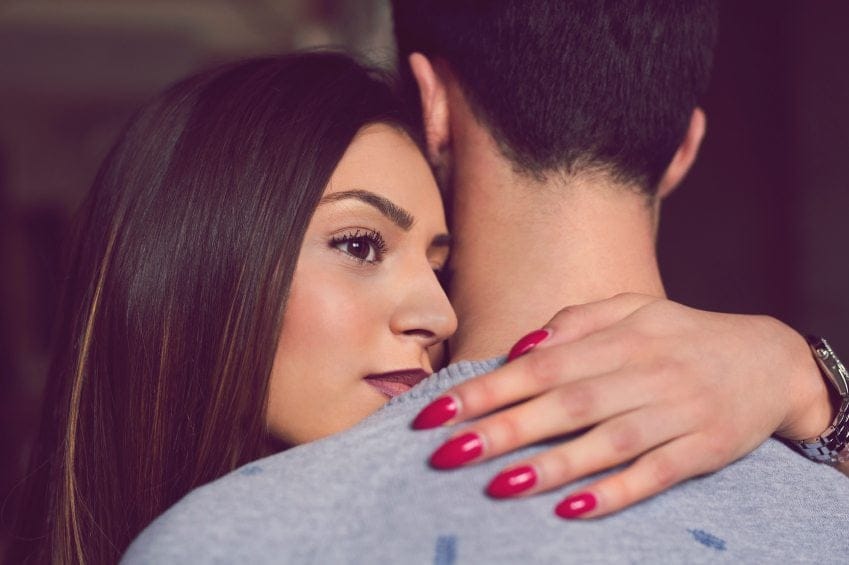 troubled woman embracing man