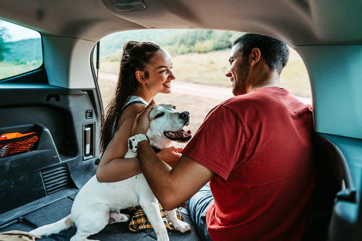 couple with dog on camping trip