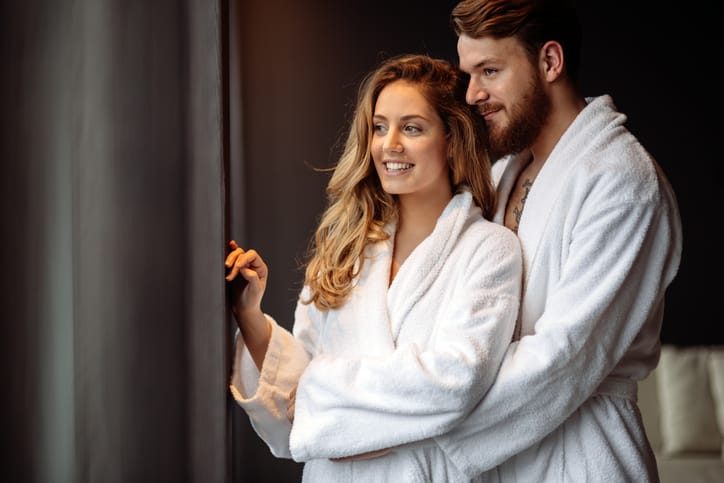 Couple in bathrobes enjoying honeymoon in spa resort