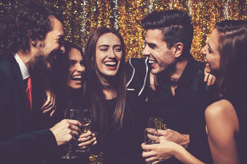 friends laughing and drinking celebrating