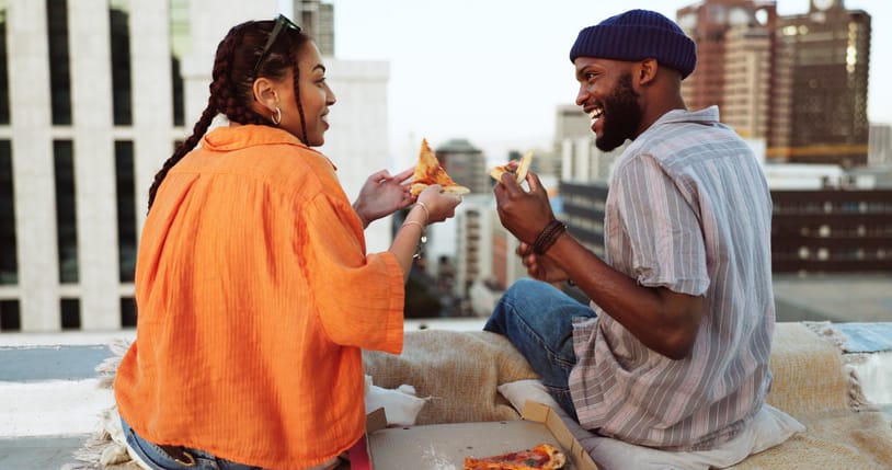 couple having picniic on city rooftop