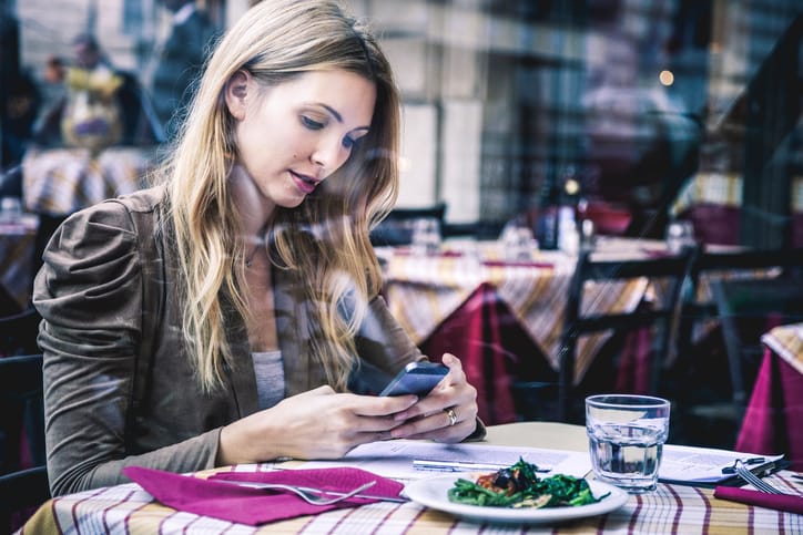 Woman seated in a restaurant having a stressed brunch