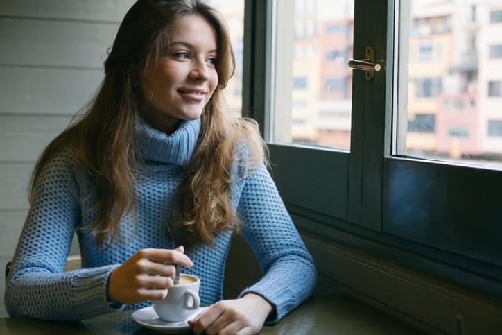 woman in blue sweater smiling