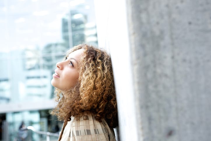 Beautiful young woman looking up