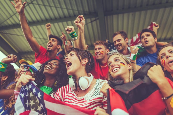 Group of different nation supporters together at a match.
