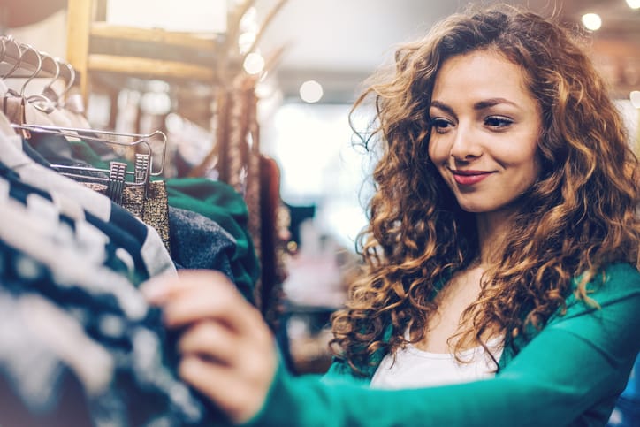 Happy young woman in a fashion store
