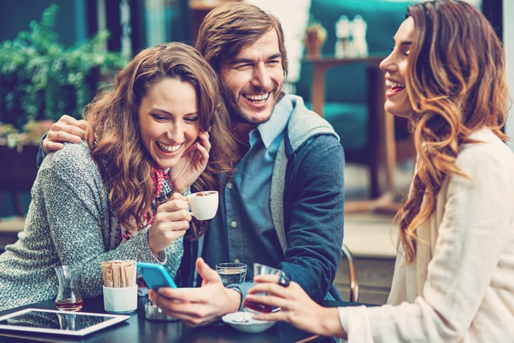 Happy couple chatting with a friend