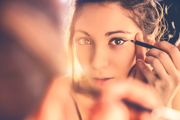 Beautiful woman applying make-up