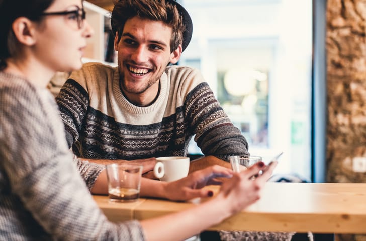 Young couple having fun at the coffee shop