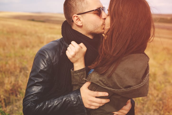 couple being sensual in a field