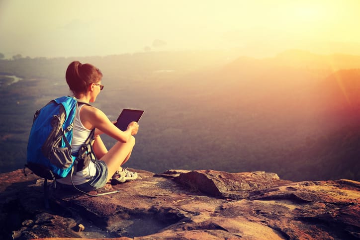 Hiking woman on a mountain peak.