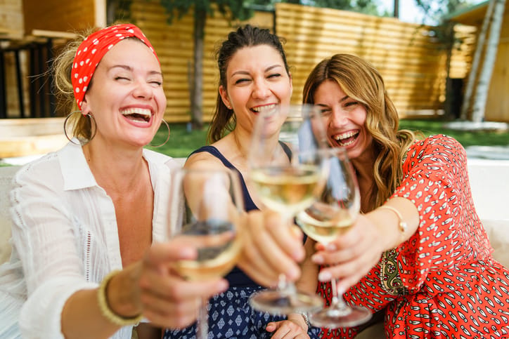 three women drinking wine