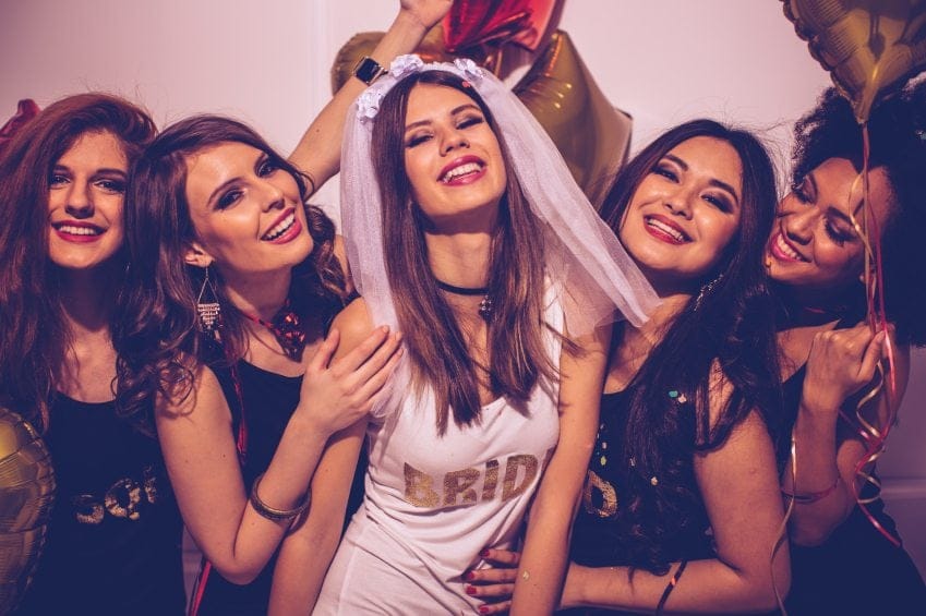 Bride and bridesmaids having fun