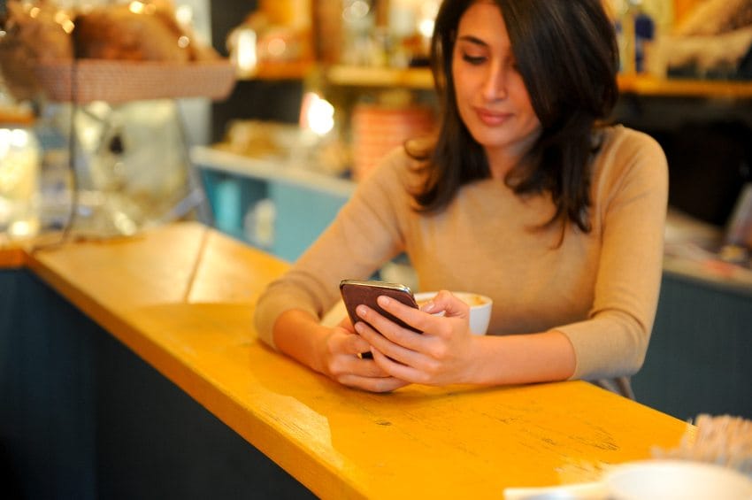 Woman in coffee shop with phone