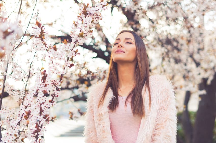 Girl standing under blossom tree