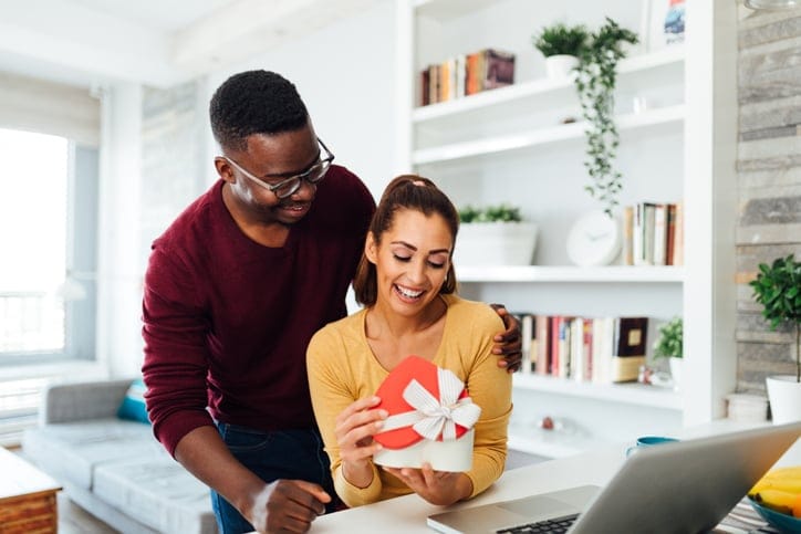 Husband giving wife a gift.
