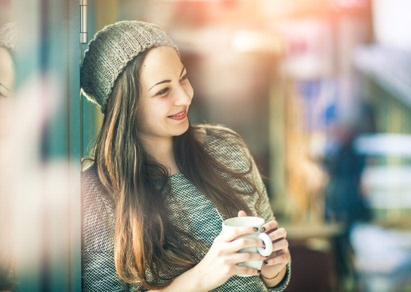 Young woman holding cup