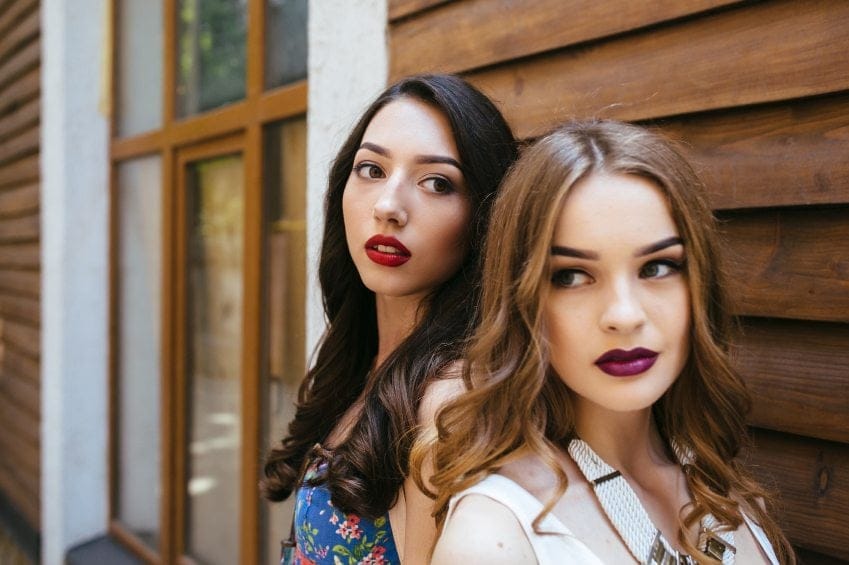 Two young beautiful girls pose