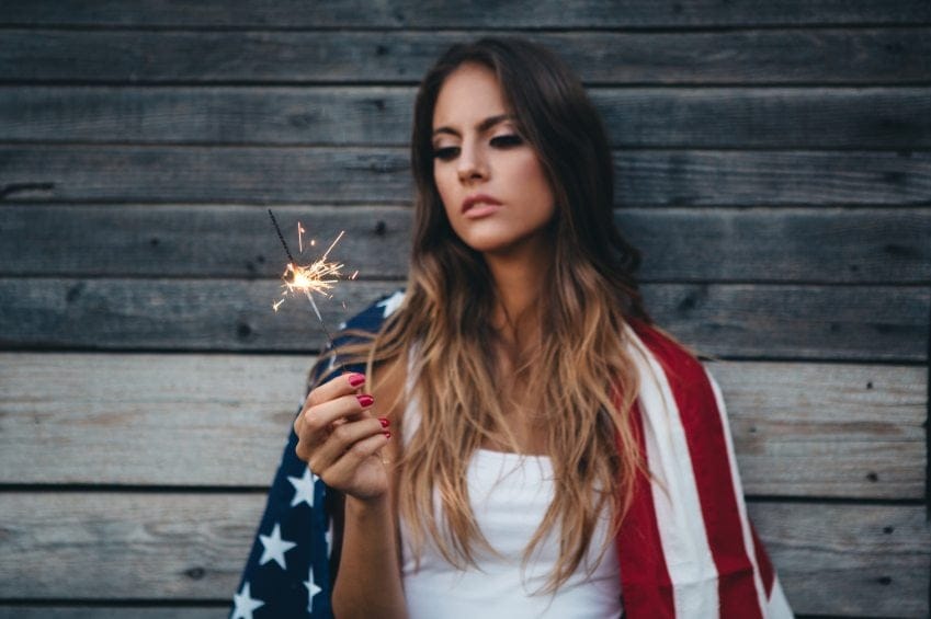 Girl with sparkler and american flag