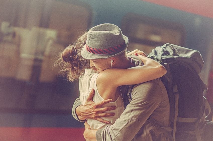 Girl embracing guy at station