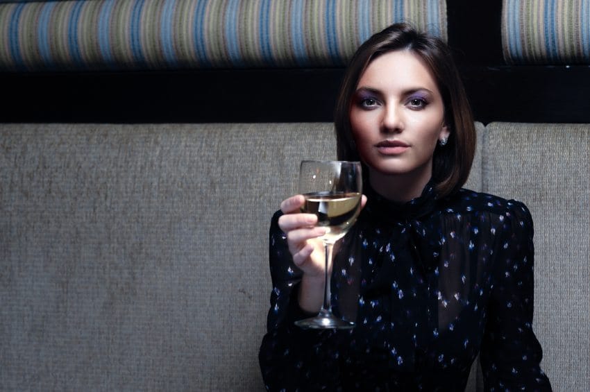 Woman drinking wine in a bar