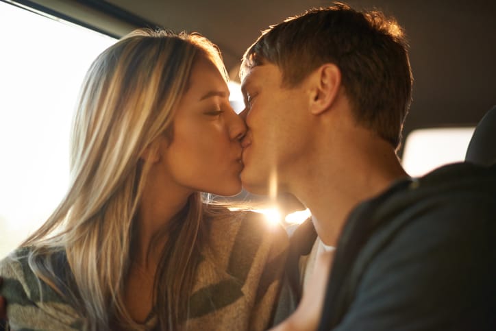 Shot of an affectionate young couple kissing in a car