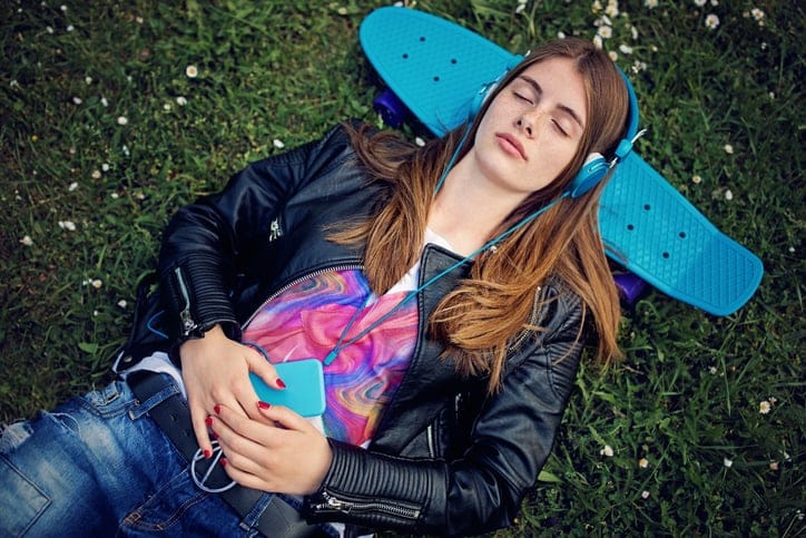 woman lying down with skateboard