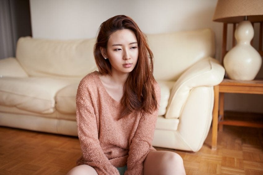 Young asian girl sat on the floor