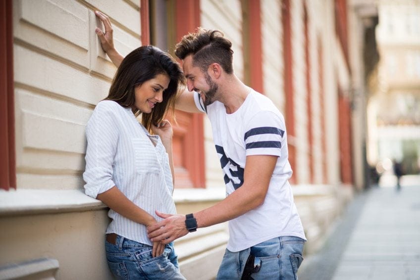 First date couple near wall