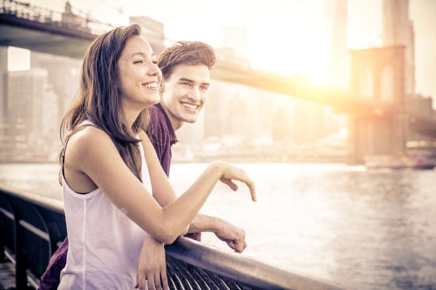 Couple looking over a bridge