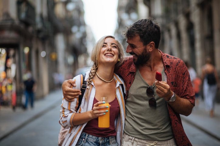 happy couple walking down street