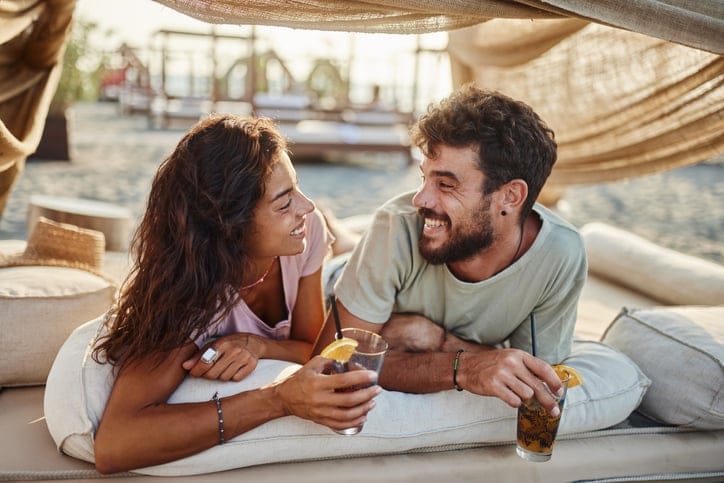 couple having drinks at beach