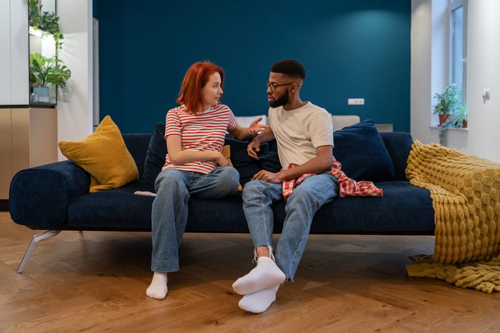 couple having serious talk on couch