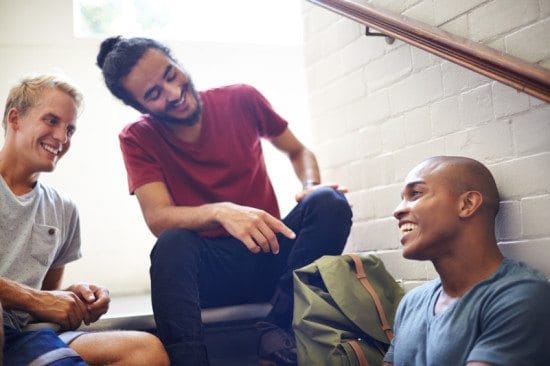 male friends chatting in stairwell