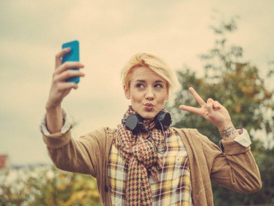 woman taking selfie with peace sign