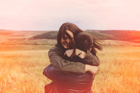 couple embracing in summer field
