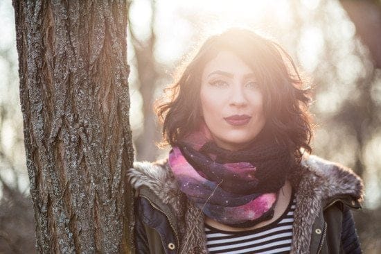 woman in winter coat by tree