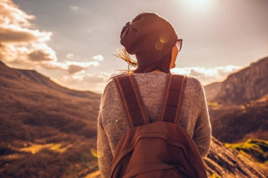 woman in beanie on mountaintop